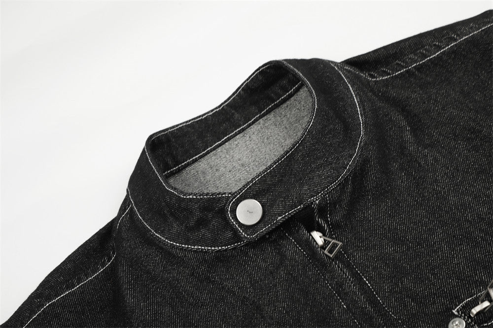 Close-up of black denim jacket stand collar with snap button and front zipper pull