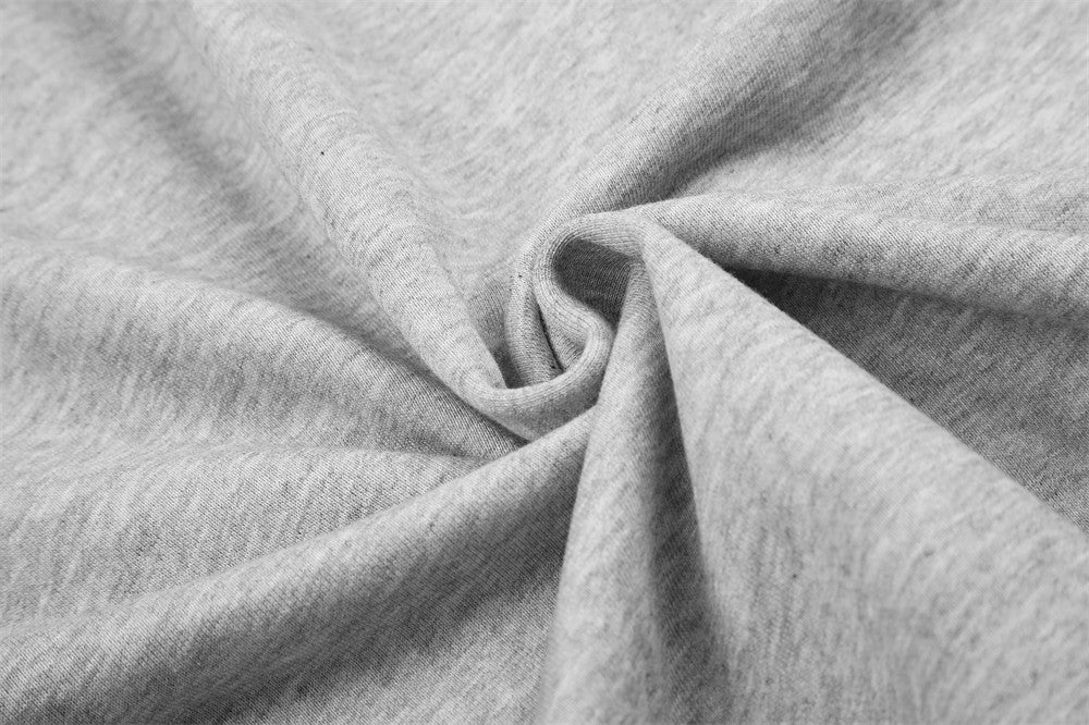 Close-up of light gray hoodie fabric texture with soft knit folds