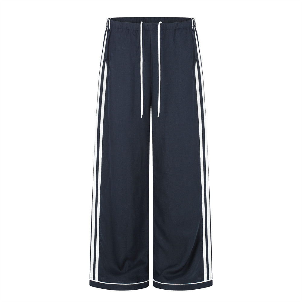 Wide-leg navy track pants with double white side stripes and white drawstring waist