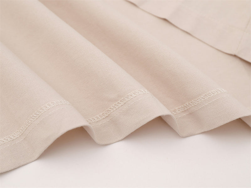 Close-up of beige shirt bottom hem with neat stitched finish