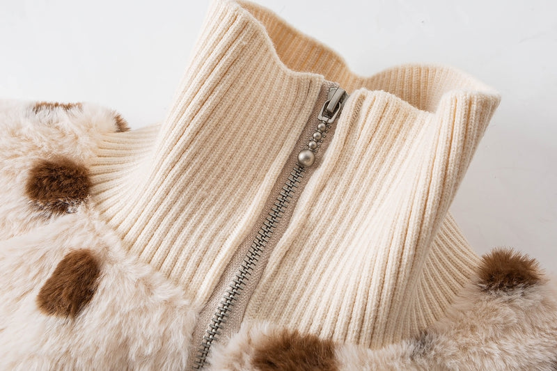 Close-up of the cream ribbed collar and metal zipper on a brown polka dot faux shearling jacket