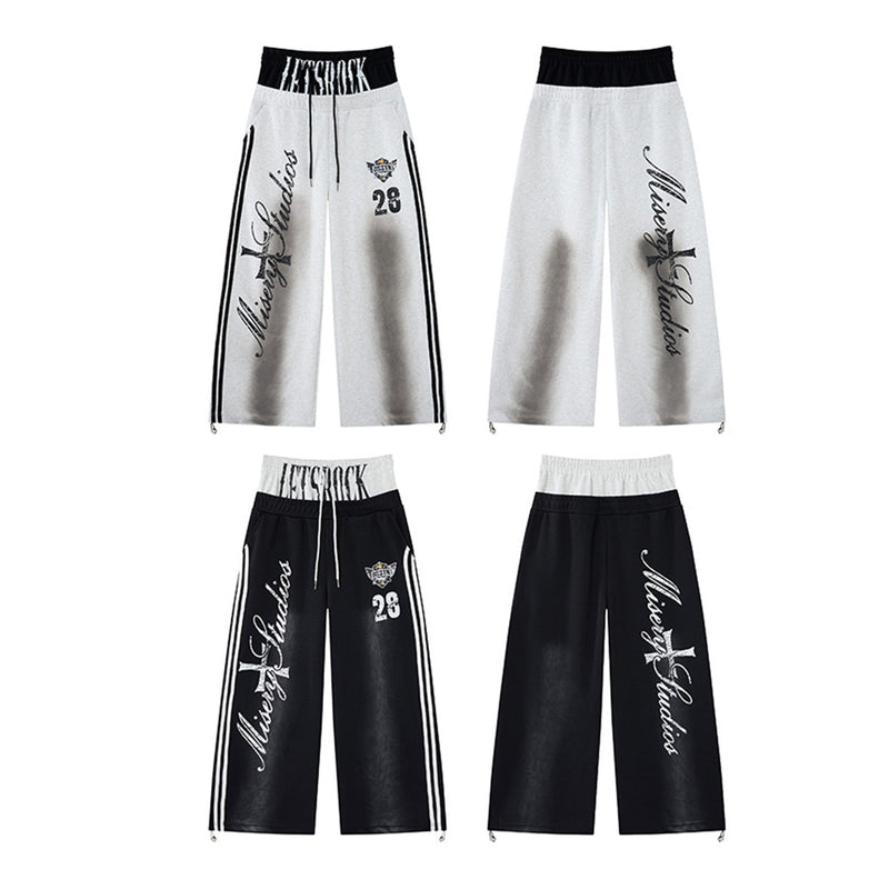 Pantalon de survêtement ample à jambes larges avec bandes latérales, fausse double ceinture et imprimé graphique