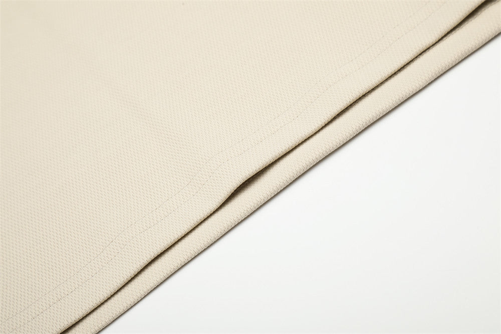 Beige hem detail with textured knit fabric and clean stitched edge