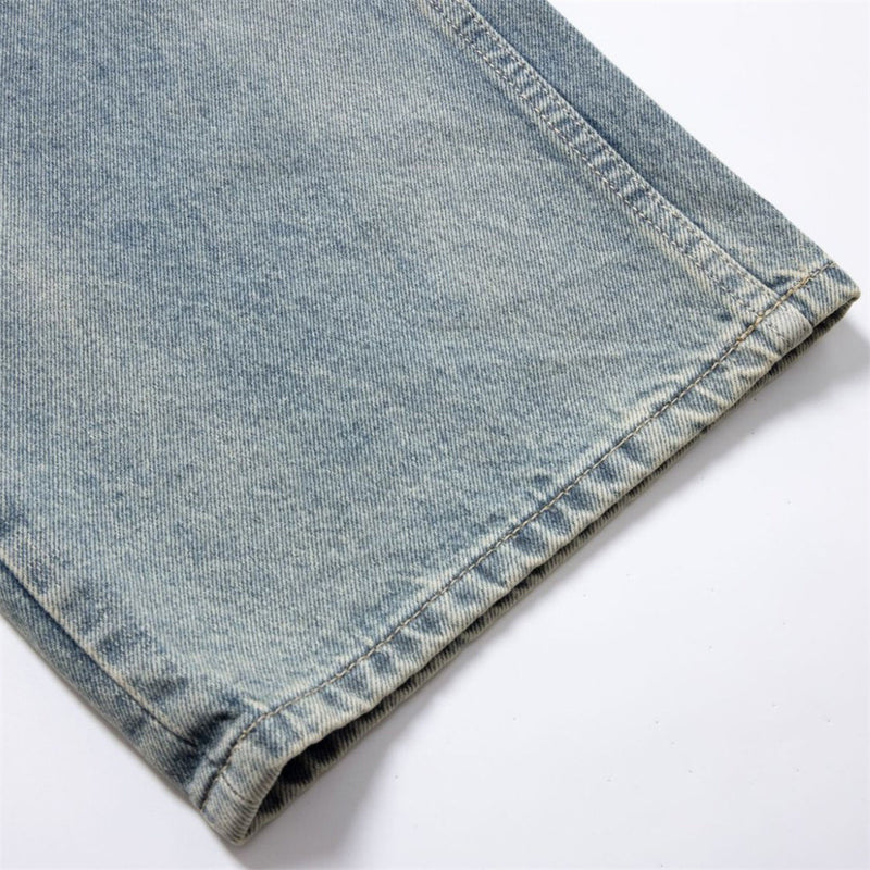Close-up of hem on light wash denim pant leg