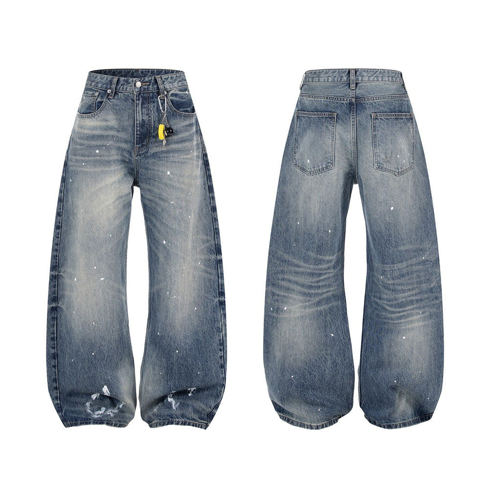 Men's baggy wide-leg jeans in vintage blue wash with white paint splatter and distressed frayed hem