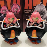 Two pink-haired Anya Forger figurines from Spy × Family, cosplaying as Frieza, are seated in sci-fi pods with green eyepieces and bases like rocky terrain. Each comes with a box featuring matching artwork.