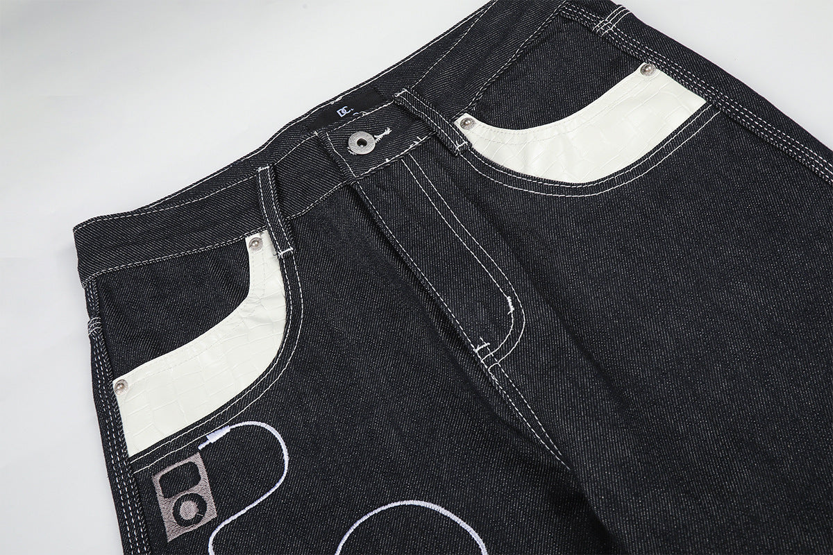 Jean baggy à jambes larges avec broderies et patch en cuir motif notes de musique — Denim noir brut