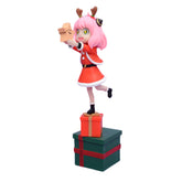 The Spy × Family Anya Forger Christmas PVC Figure - 18cm Holiday Edition features Anya in a festive red Santa outfit with antlers and pink hair, joyfully holding a small gift while standing on two stacked gift boxes, one red and one green, against a white backdrop.