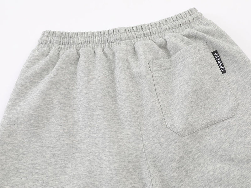 Pantalon de survêtement à jambes larges avec graphisme graffiti et ourlet orné de détails métalliques