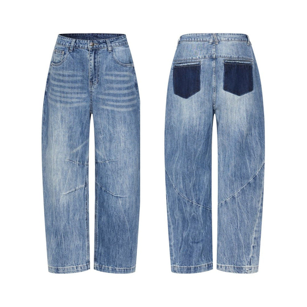 Men's wide-leg baggy jeans in washed medium blue denim with curved seam panels and contrast dark-blue back pocket, front and