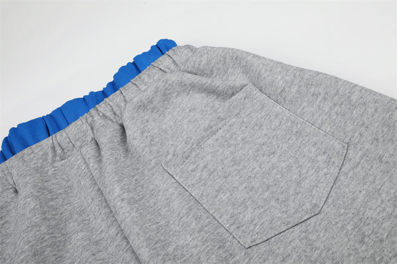 Close-up of gray sweatpants back pocket stitched on the right side
