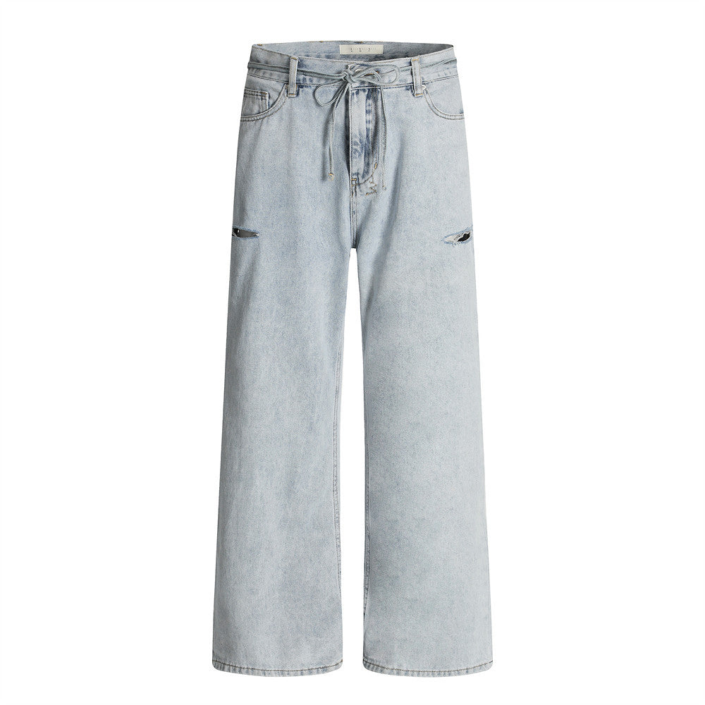 Wide-leg light blue acid-washed distressed jeans with drawstring waist, front and back view