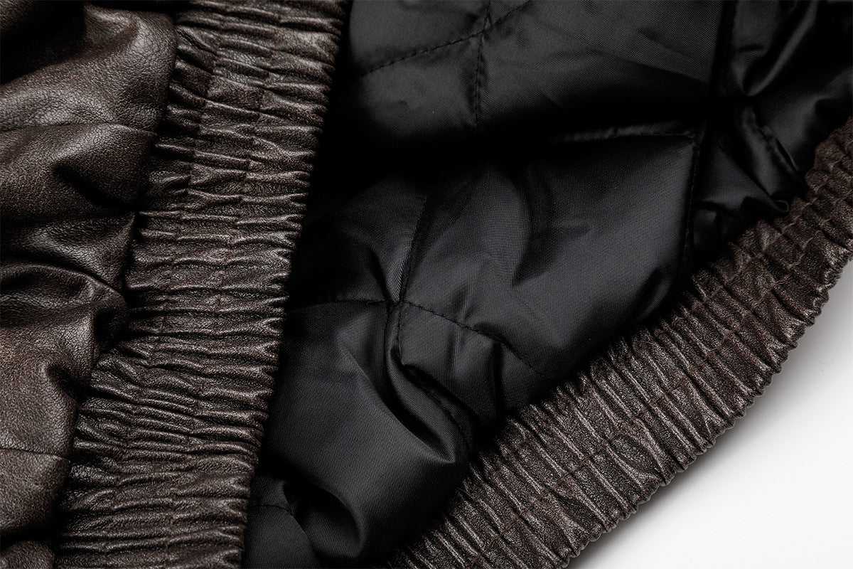 Close-up of black quilted lining and ribbed brown jacket hem