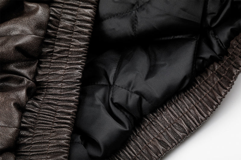 Close-up of black quilted lining and ribbed brown jacket hem