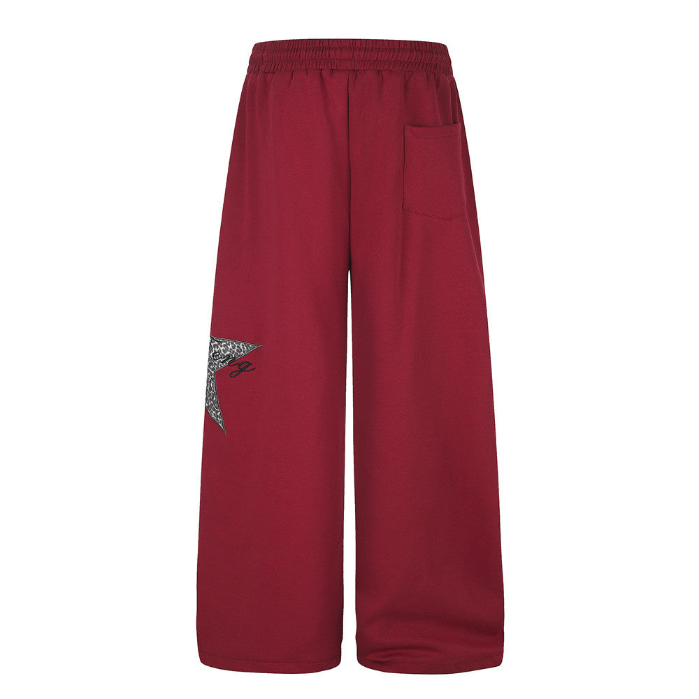 Red wide-leg sweatpants with back pocket and leopard star patch on the leg