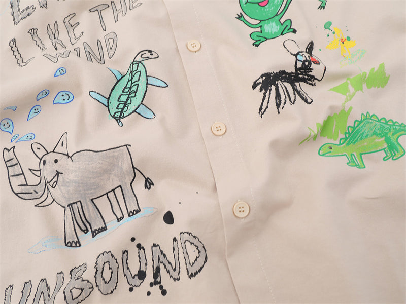 Close-up of shirt front graphic with elephant, turtle, frog, and text print