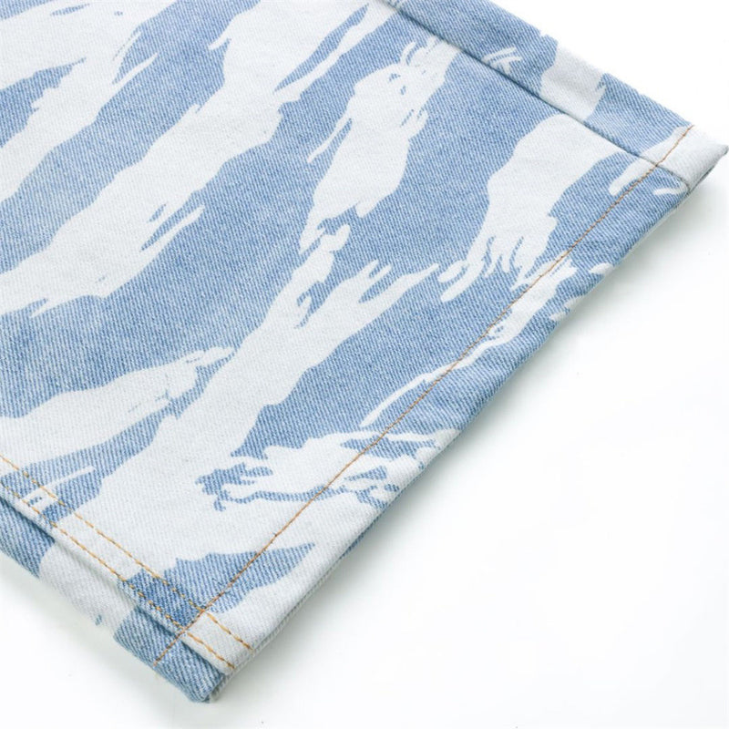 Close-up of hem on light blue zebra camo wide-leg jeans