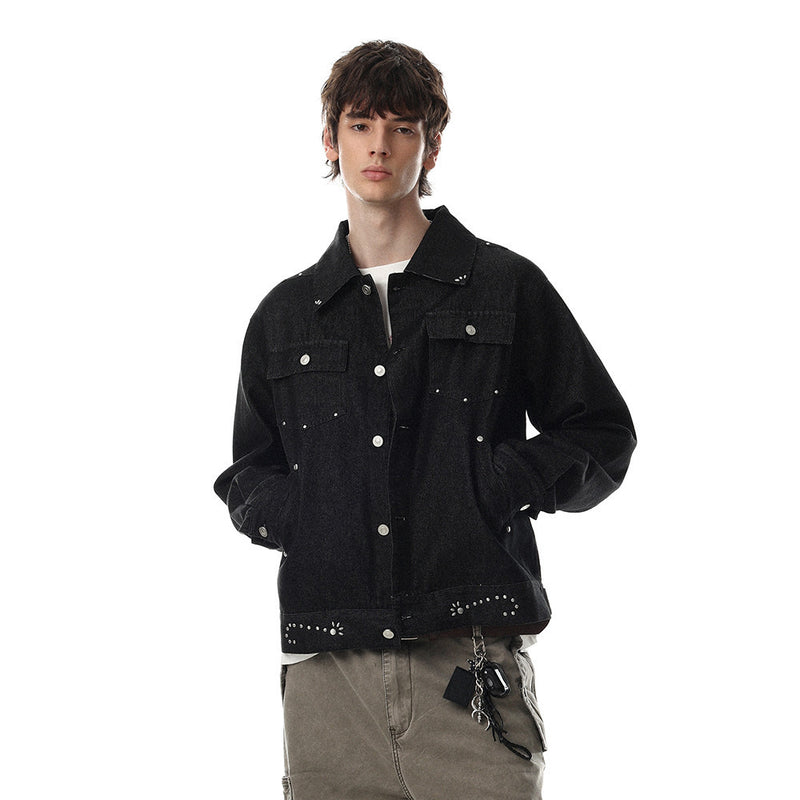 Men's cropped studded denim trucker jacket in washed black with silver rivet and stud embellishments, front view