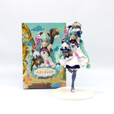 The Hatsune Miku Panda-themed 18cm PVC Figure features Miku with teal hair, a white and blue dress, and a panda on a white base. It comes in a colorful box with character artwork, making it a charming collectible display.