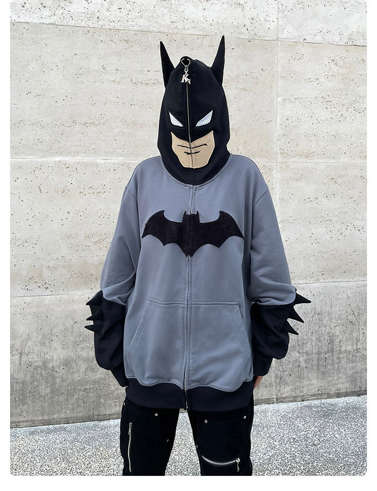 Wearing a Seakoff Batman-Inspired Hoodie, this oversized grey and black zip-up sweatshirt boasts a bold chest bat symbol and hood designed like Batman&