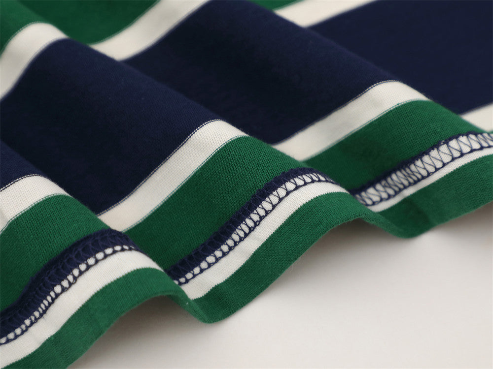 Close-up of striped shirt fabric with stitched hem detail