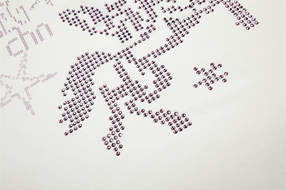 Close-up of rhinestone horse graphic on white polo shirt, cropped lower chest area