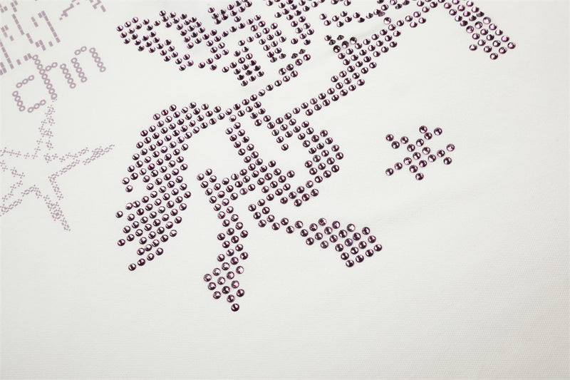 Close-up of rhinestone horse graphic on white polo shirt, cropped lower chest area