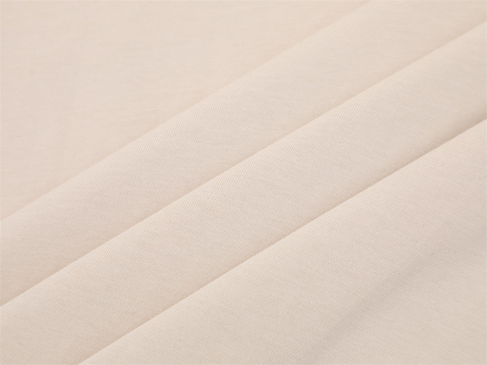 Close-up of cream fabric texture with soft folded drape