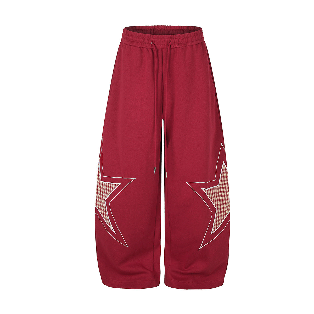 Oversized wide-leg sweatpants with large plaid star appliqué on each leg, shown in deep red with elasticated drawstring waist