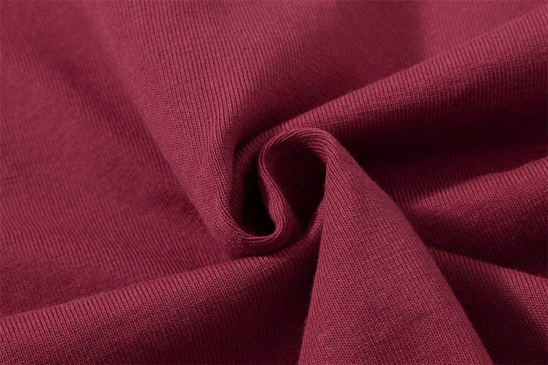 Close-up of burgundy knit fabric twisted into a swirl