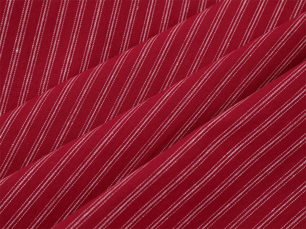 Close-up of red striped fabric folds showing fine white pinstripes