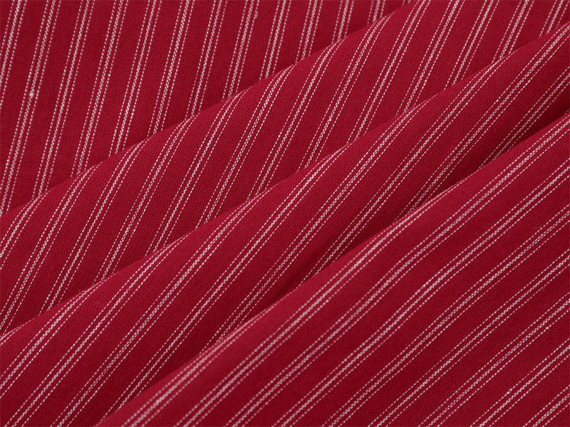 Close-up of red striped fabric folds showing fine white pinstripes