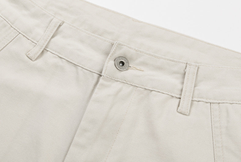 Cream waistband detail with button closure and belt loops