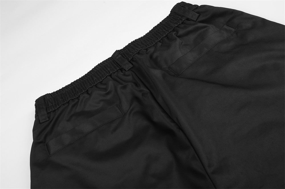Wide-Leg Pleated Trousers – Oversized Silhouette with Curved Hem