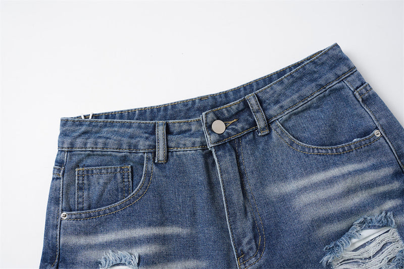 Close-up of blue denim waistband with button closure and front pockets