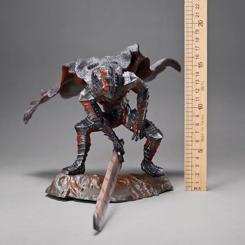 The Berserk Guts Bloodstained Warrior Statue is a 1/7 scale PVC figure featuring intricate dark armor with wings, a large sword, and cloak. It stands on a rocky base, measuring approximately 18 cm in height.