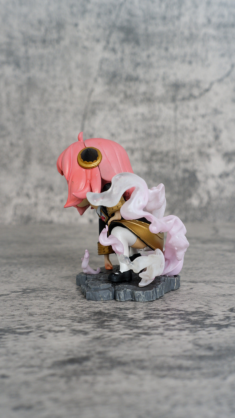 The Spy x Family Anya Forger PVC Figure, featuring a pink-haired figure with a cape on a gray rock-like base, showcases intricate outfit details and flowing white elements. Its textured gray background enhances the charm of this 9.5 cm Luffy Cosplay collectible with double head replacement options.