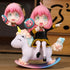 The Spy x Family Anya Forger PVC Figure features a pink-haired anime character with cat ears, green eyes, wearing a black and yellow outfit. She rides a white winged unicorn rocking horse. A smaller image shows Anya&