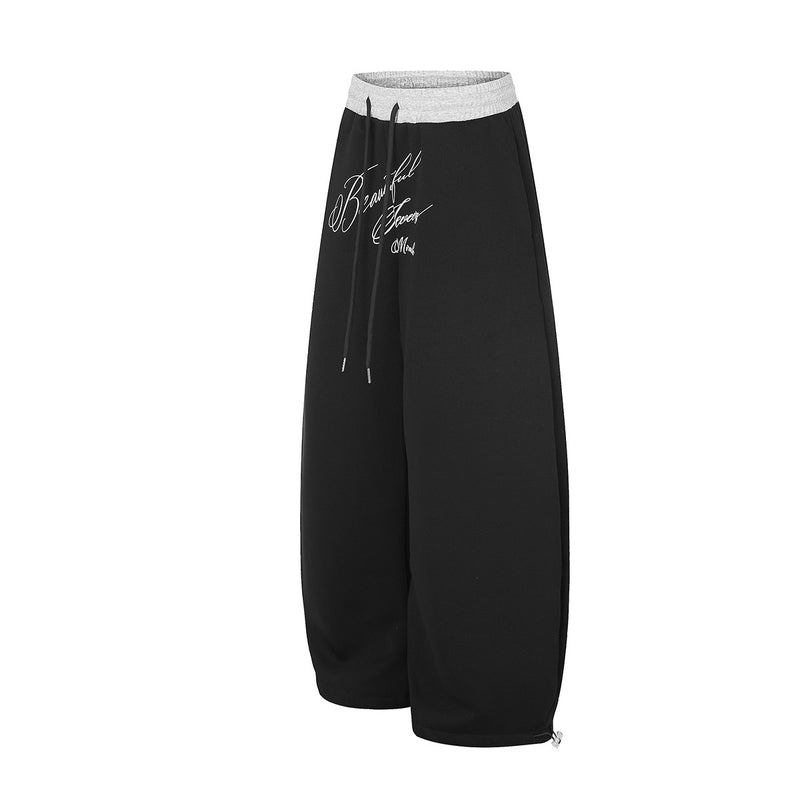 Pantalon de survêtement large à inscription et ceinture contrastante