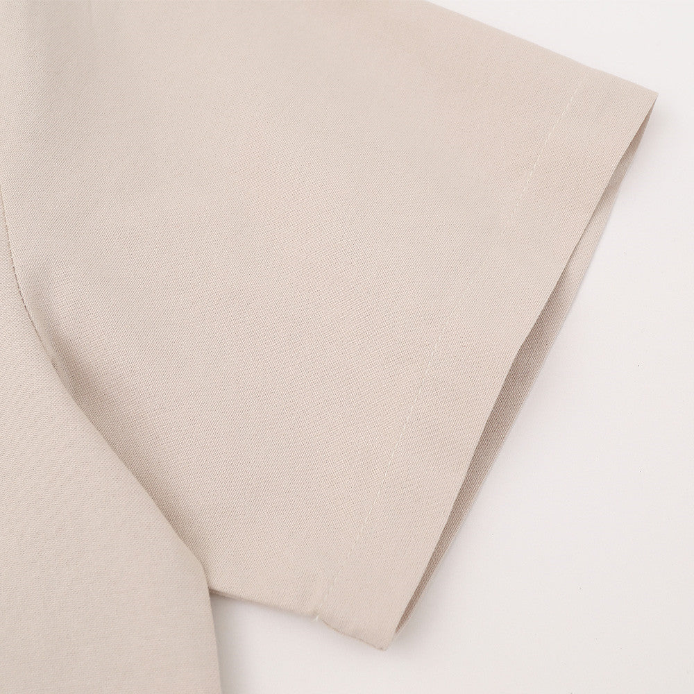 Close-up of beige short sleeve shirt sleeve in textured woven fabric
