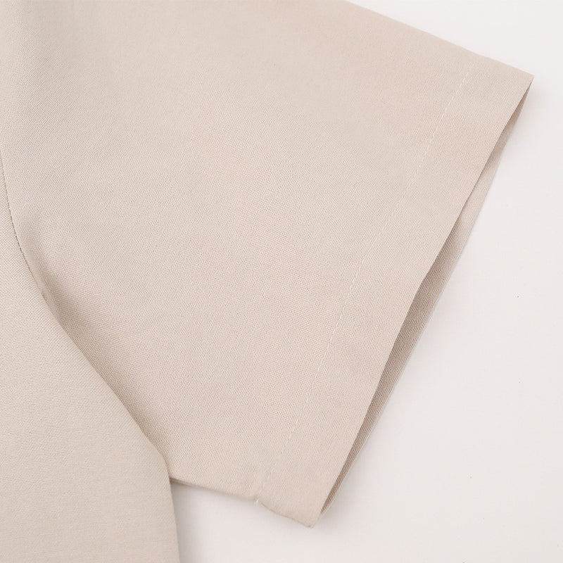 Close-up of beige short sleeve shirt sleeve in textured woven fabric