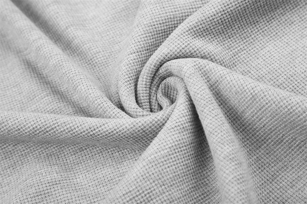 Close-up of gray tee waffle knit fabric gathered in a swirl