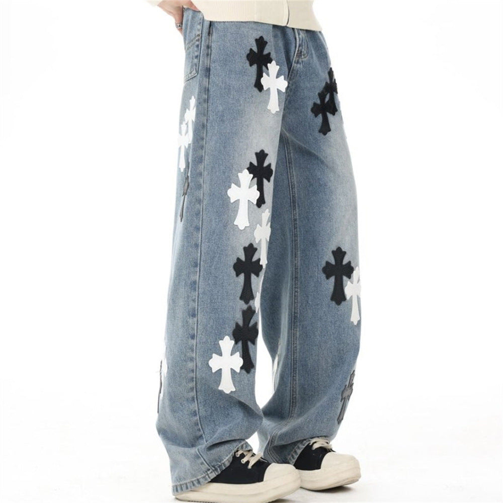 Light wash baggy jeans with cross patches, angled side view on model