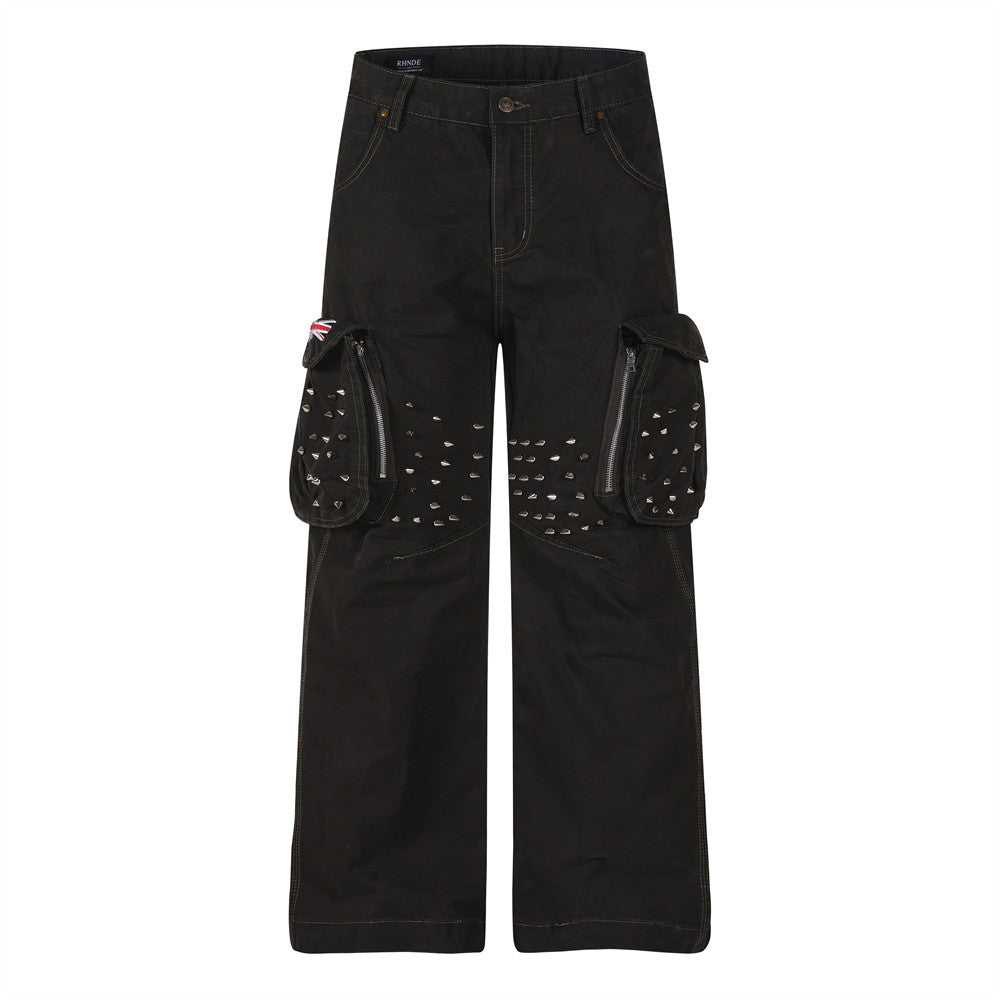Front view of black cargo pants with studded flap pockets and wide straight legs