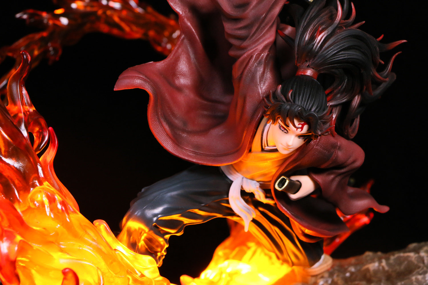 The Demon Slayer Tsugikuni Yoriichi 29cm PVC statue strikes a dynamic combat pose, depicting the Breath of the Sun with flame effects. This high-quality anime collectible has long dark hair, a flowing red robe, dark pants, and wields a sword with determination.