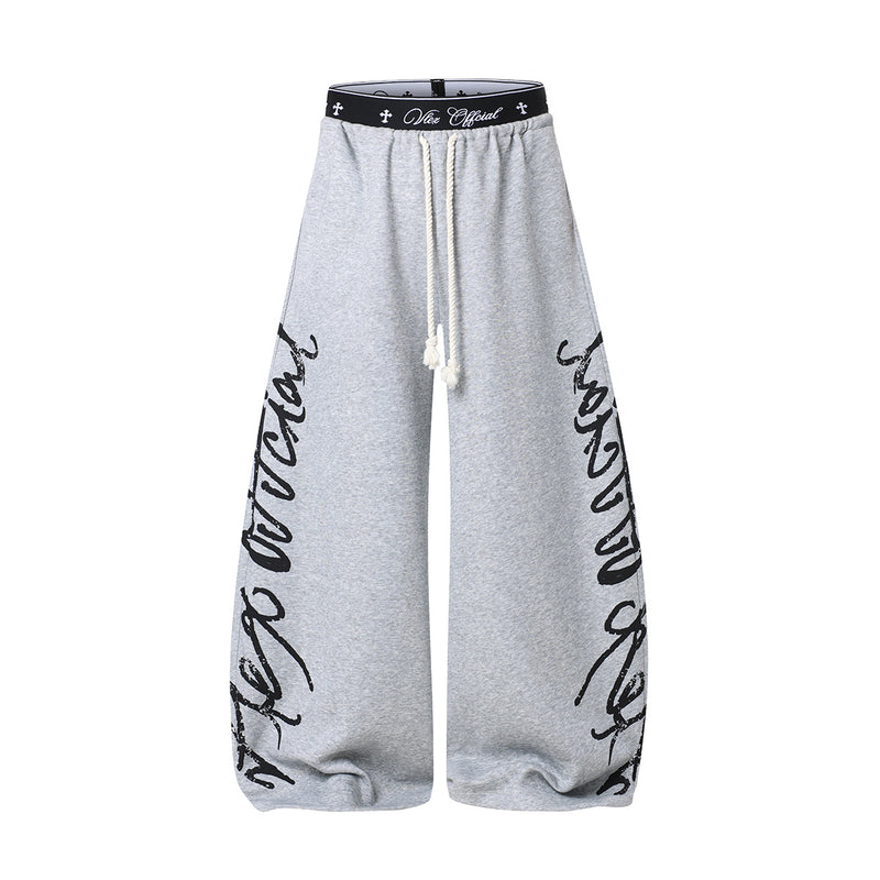 Pantalon de survêtement à jambes larges avec imprimé graffiti cursif et ceinture élastiquée siglée