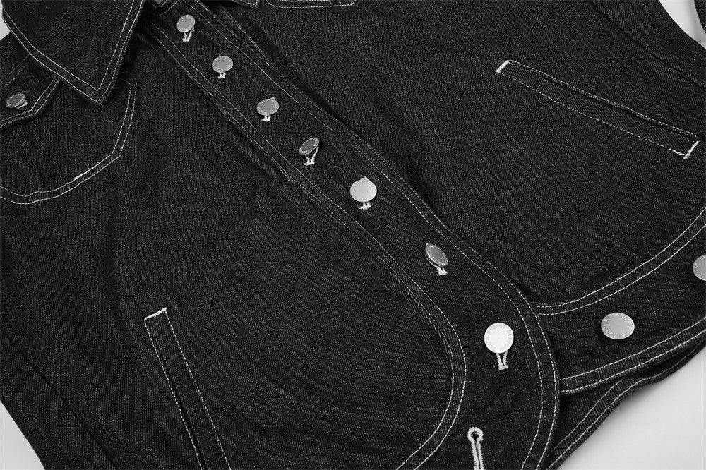 Front of black denim jacket laid flat, showing snap placket, pockets and contrast stitching