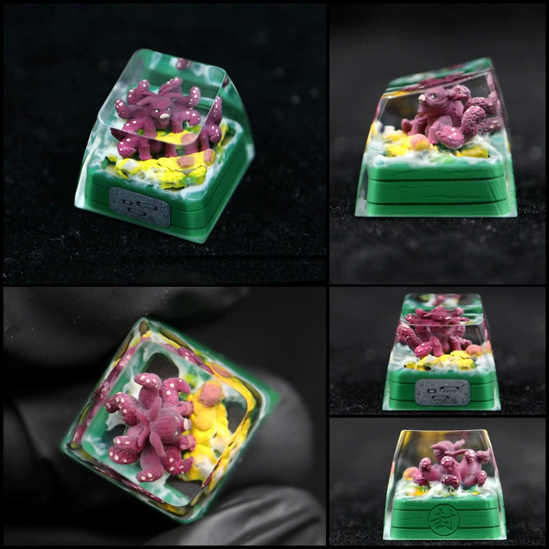 An image collage showcases a Naruto Bijuu collection keycap, featuring a miniature red octopus with white speckles in clear resin. The green base includes decorative elements that mimic an aquatic scene.