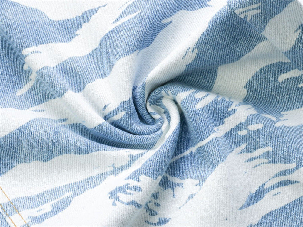 Close-up of soft folded light blue zebra camo denim fabric