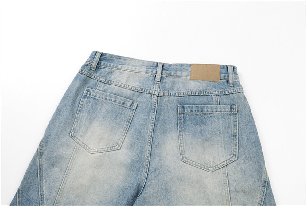 Back waistband and pockets of light blue denim shorts with tan patch detail